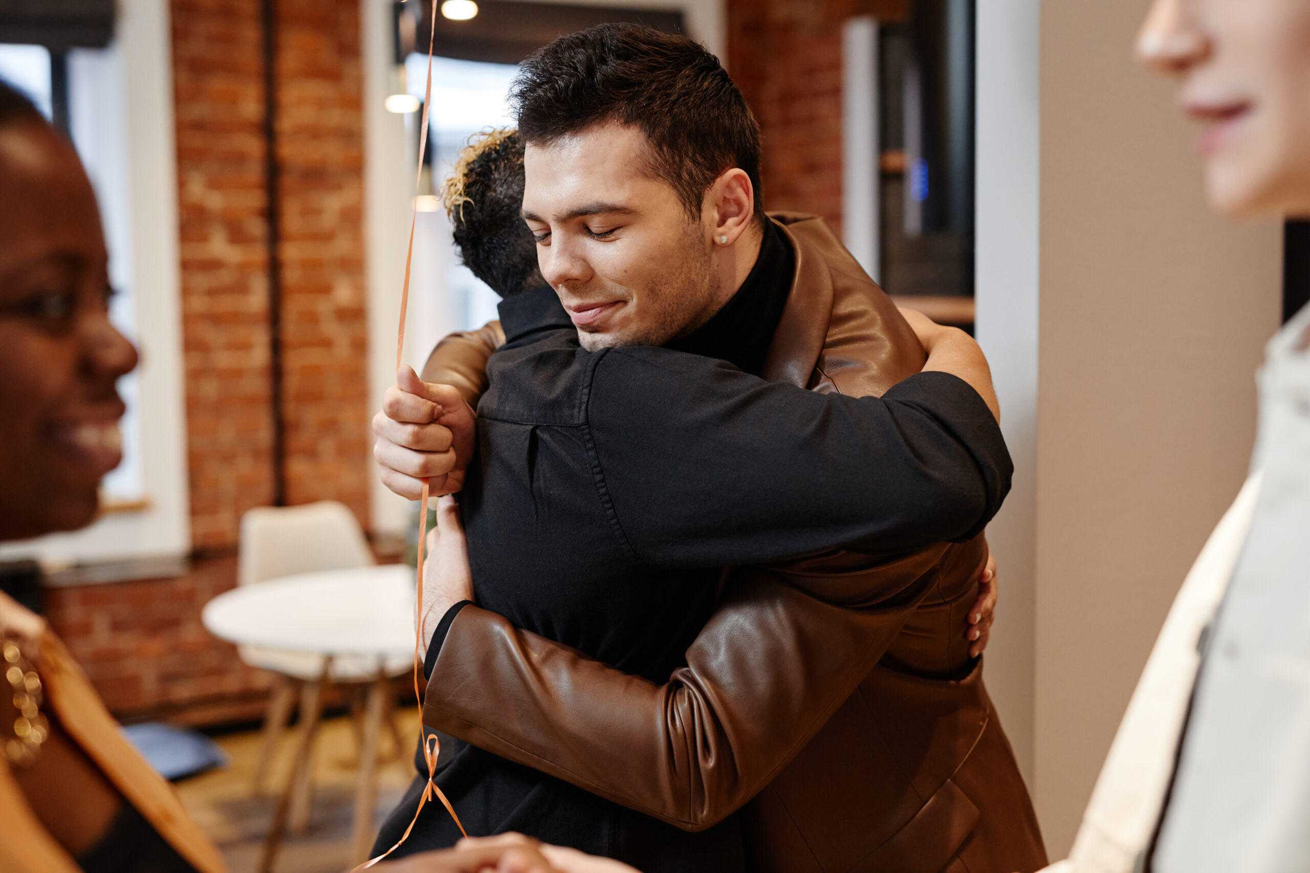 Two Working Wardrobes participants greeting each other warmly after a job readiness session