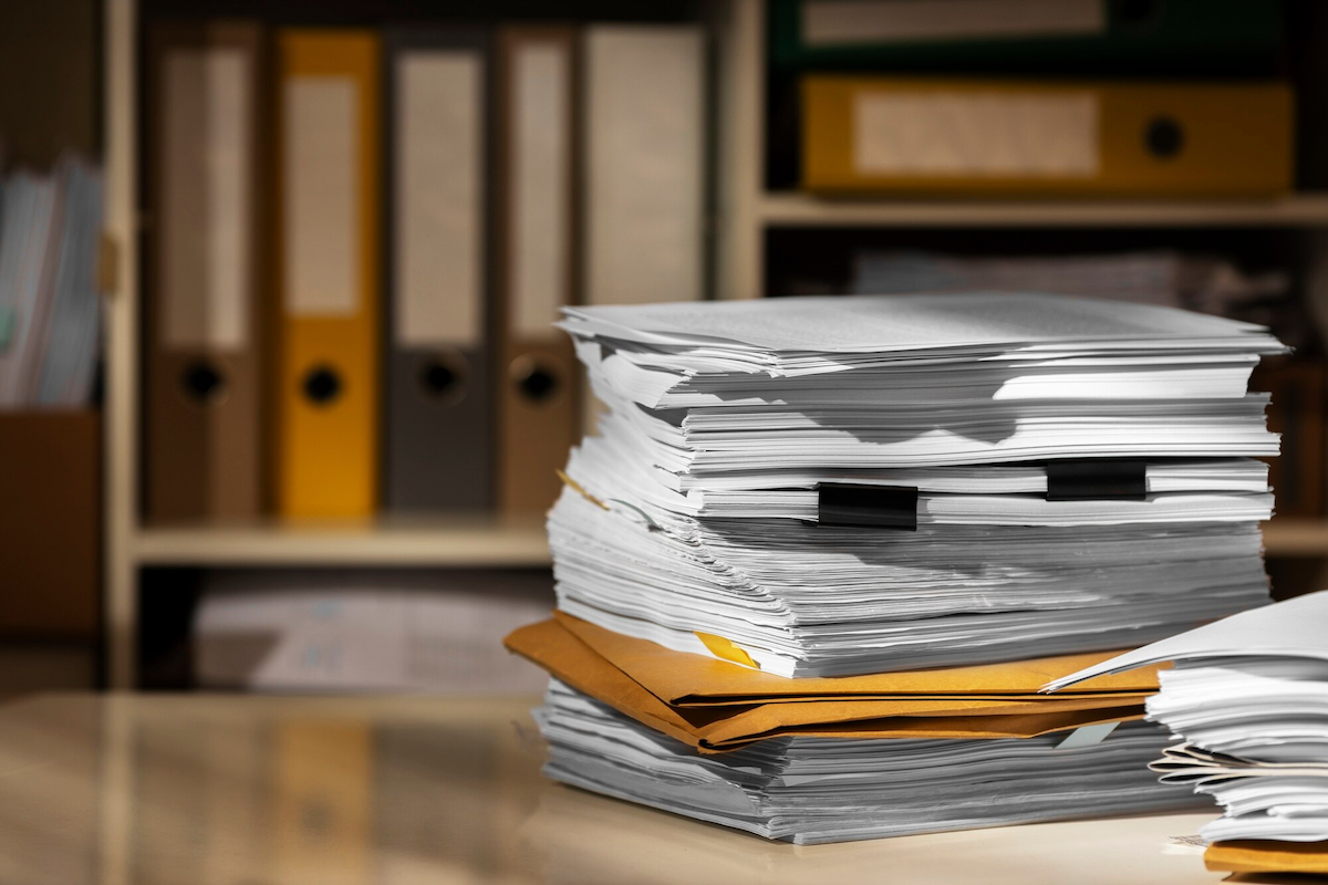 Caseworker writing structured case notes at a desk